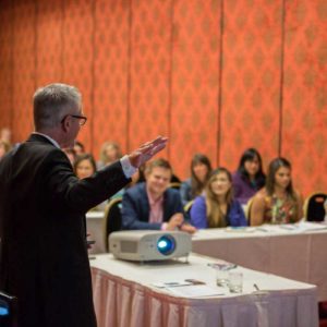 Speaker addressing in-person audience